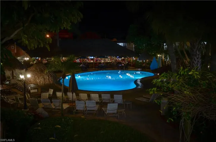 Pool at night with a patio