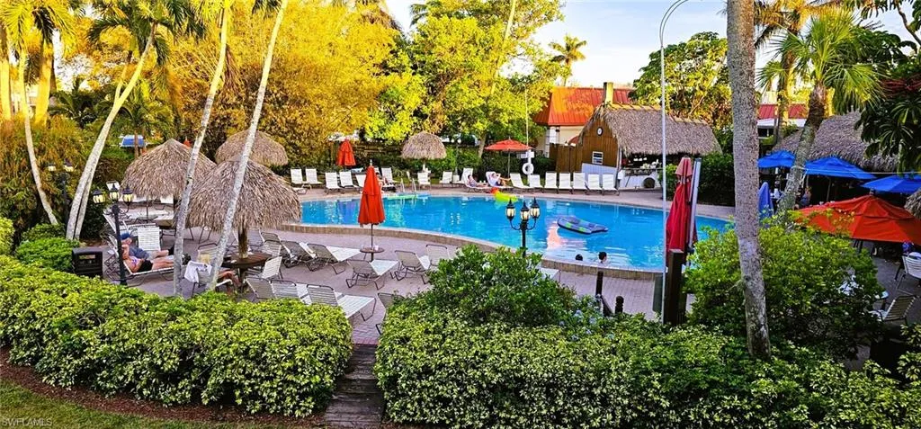 View from the condo of pool with a patio area
