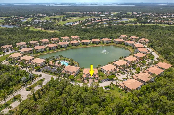 Aerial view of property and surrounding area with nearby suburban area and a nearby body of water