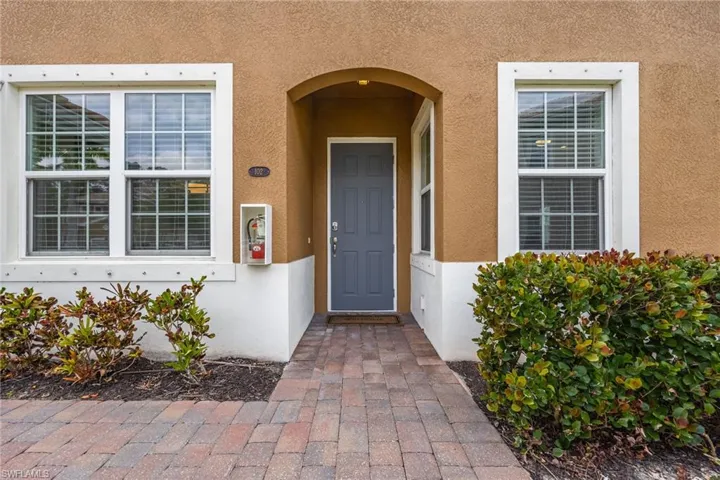 Entrance to property with stucco siding