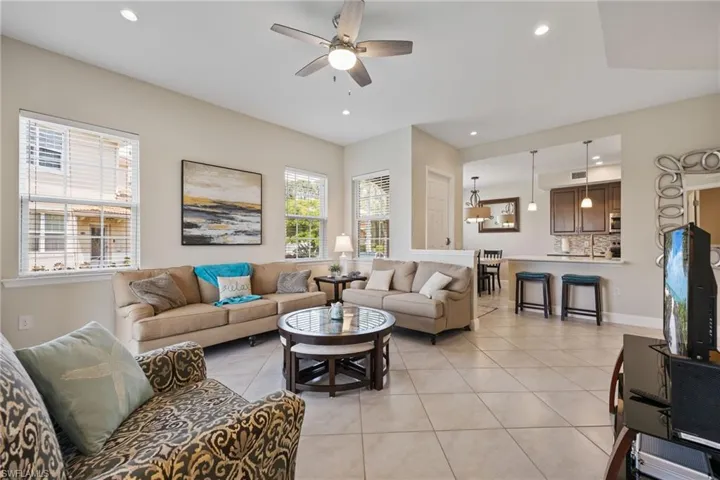 Living area featuring light tile patterned floors, recessed lighting, and ceiling fan
