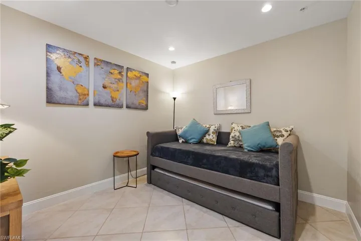 Den/Bedroom featuring light tile patterned flooring and recessed lighting