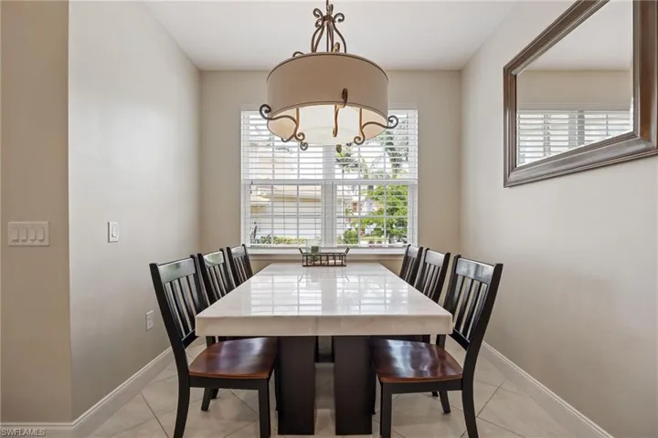 Dining space featuring plenty of natural light and light tile patterned floors