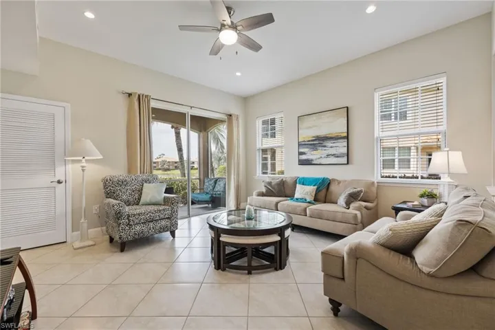 Living area featuring light tile patterned floors, healthy amount of natural light, recessed lighting, and a ceiling fan