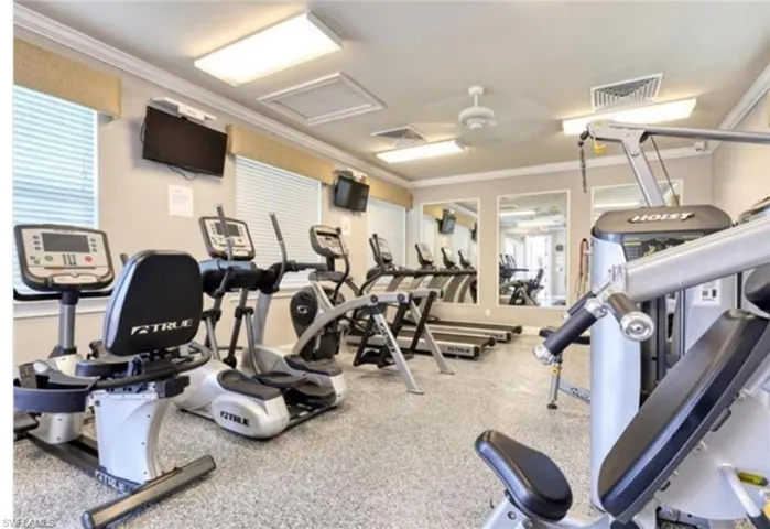 Exercise room featuring crown molding