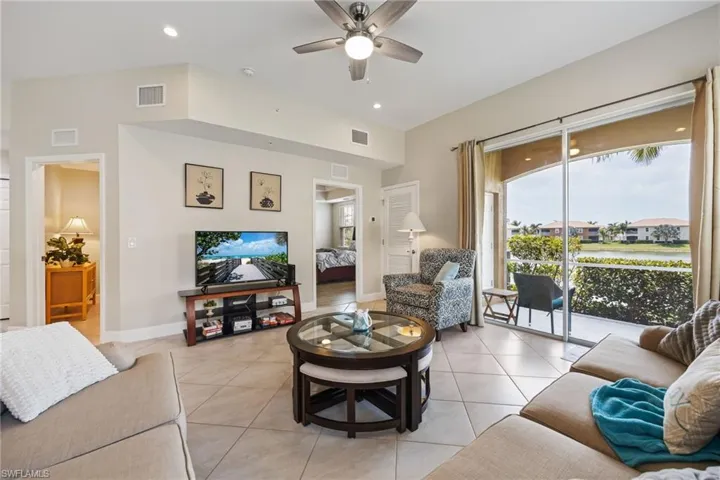 Living area with light tile patterned floors, recessed lighting, and a ceiling fan