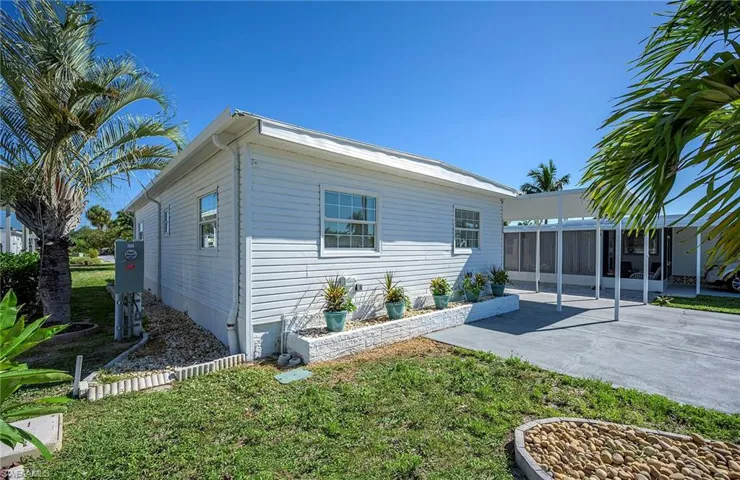 Back of property featuring a yard and a patio area