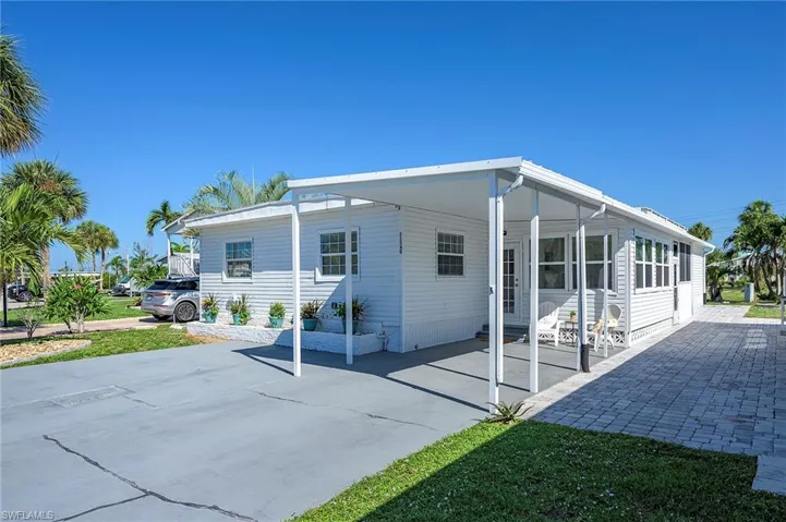 Back of house with a carport