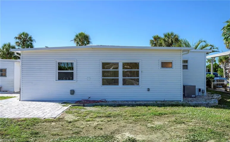 Back of house featuring a patio and a lawn