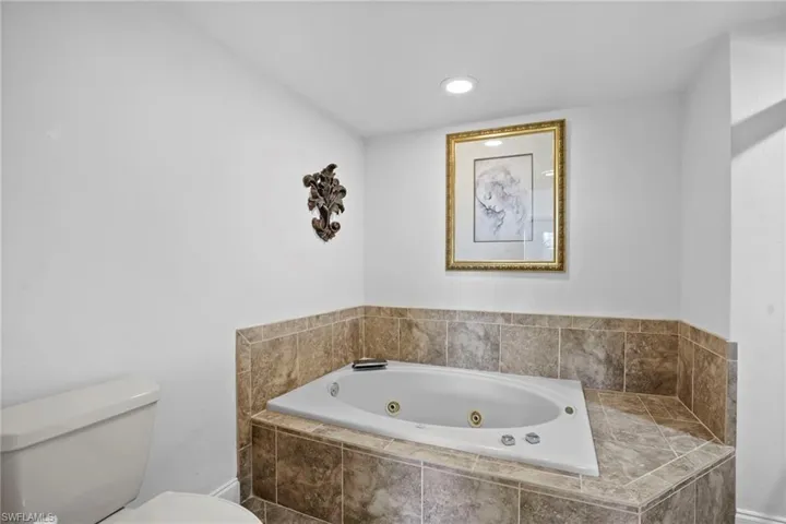 Bathroom with a whirlpool tub and recessed lighting