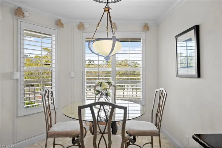 Dining area featuring baseboards and crown molding
