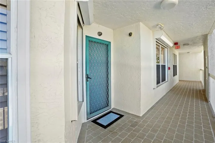 Entrance to property featuring stucco siding