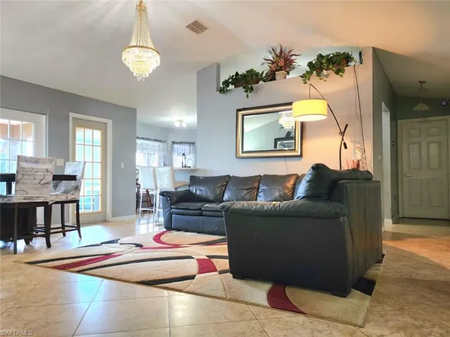 Living room with lofted ceiling and a chandelier