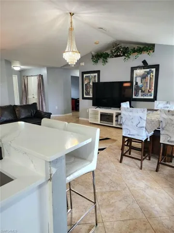 Dining area with lofted ceiling and an inviting chandelier