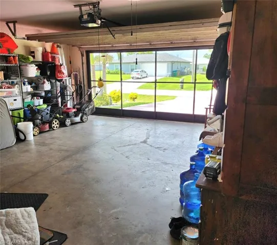 Garage featuring a garage door opener and Garage Door Screen