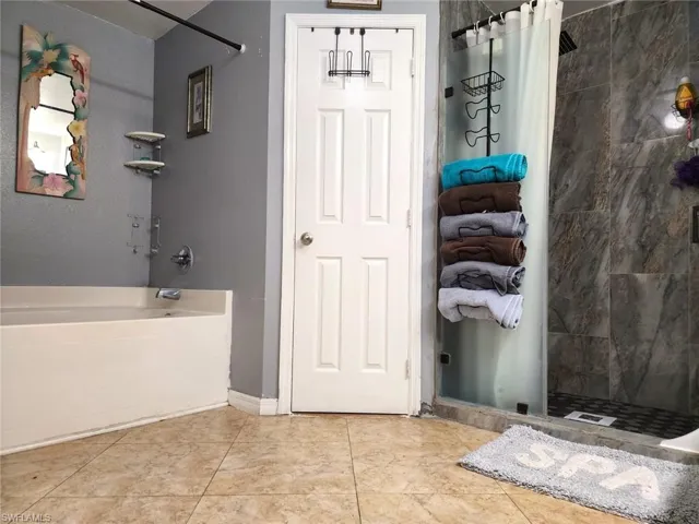 Bathroom featuring independent shower and bath