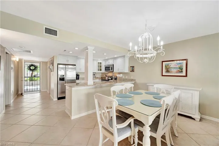 Dining area/kitchen with view toward screened front door offering great cross - breezes!
