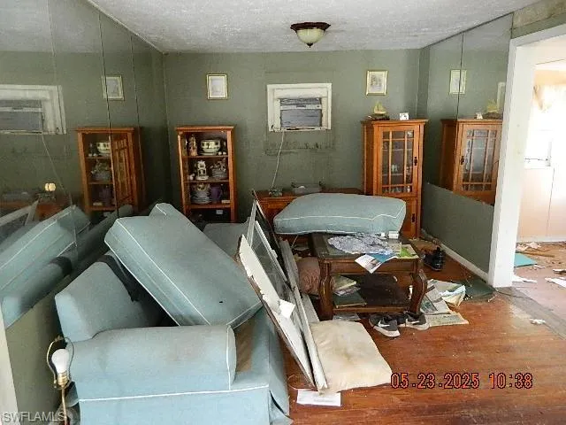 Living room with wood finished floors and a textured ceiling