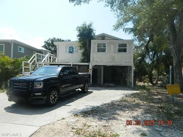 Coastal inspired home with concrete driveway