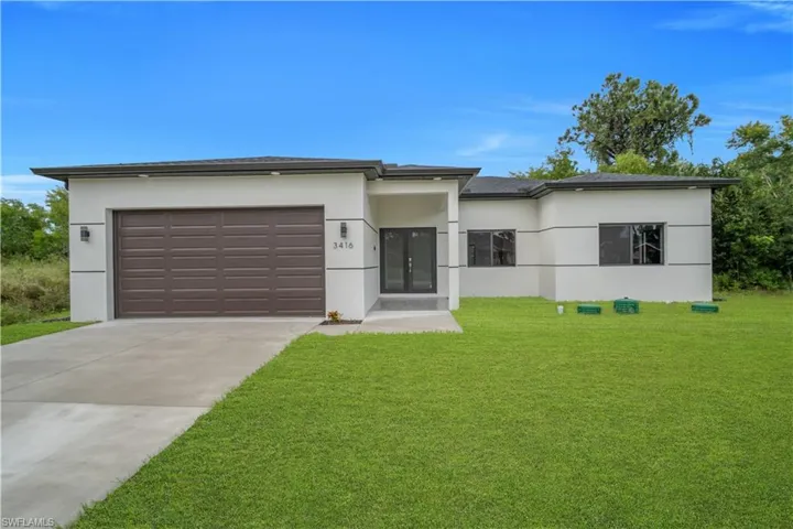 Contemporary single-story residence with a dark brown garage door, dark-framed windows, and a paved driveway leading to the entrance