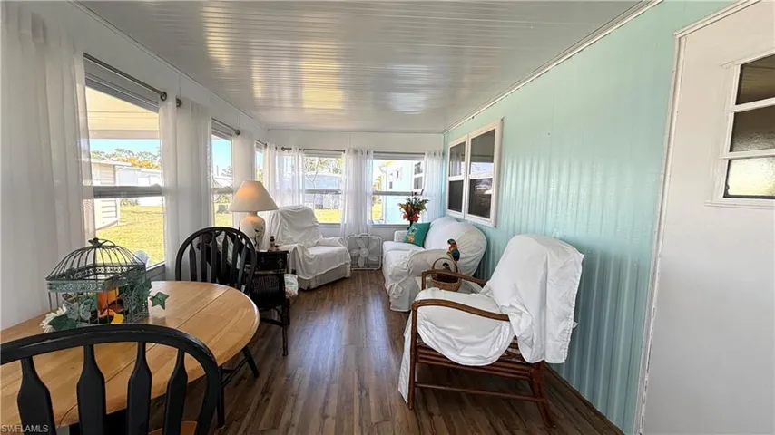 New windows, new doors, and lustrous wood laminate floor in the sunny Florida room.