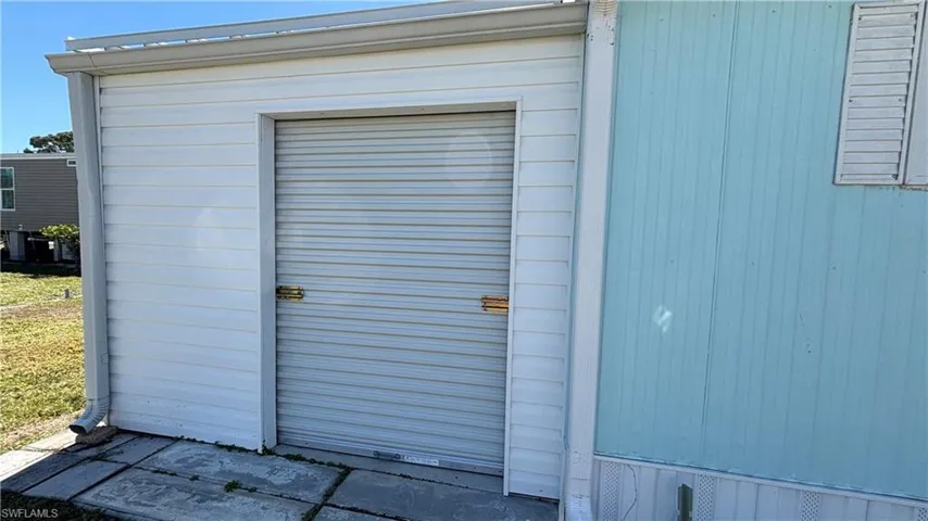Golf cart garage with roll-up door offers plenty of storage space.
