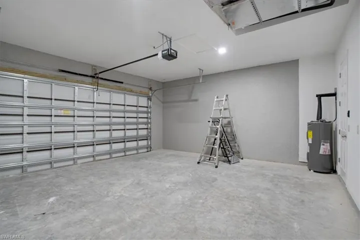 Garage with a garage door opener and water heater