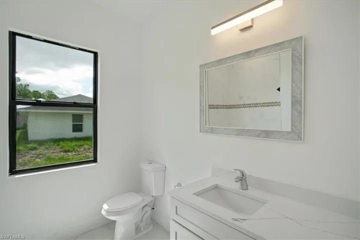 Bathroom featuring oversized vanity and toilet