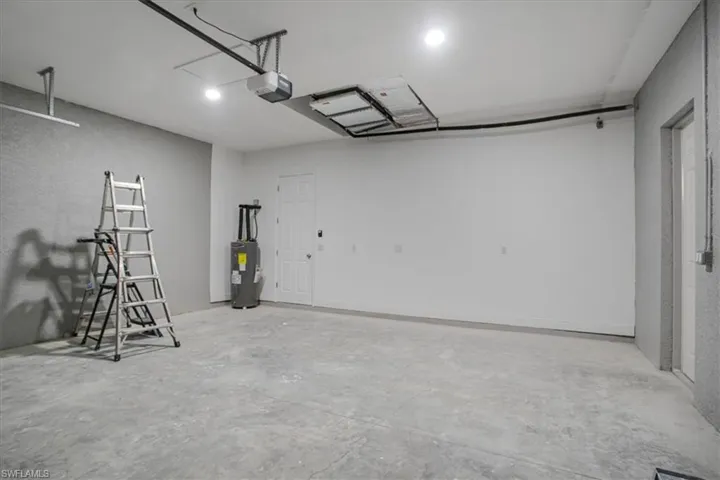 Garage with a garage door opener and water heater