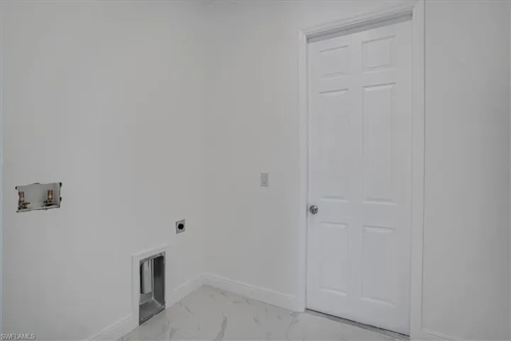 Washroom with tile floors, hookup for an electric dryer, and hookup for a washing machine