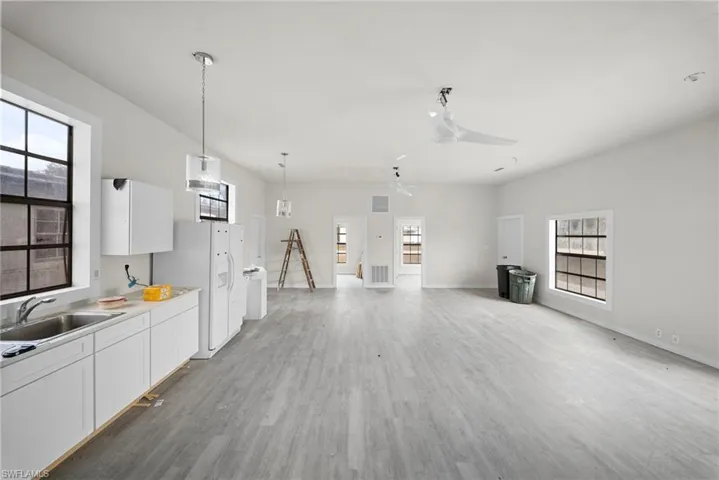 Unfurnished living room with light wood finished floors and a ceiling fan