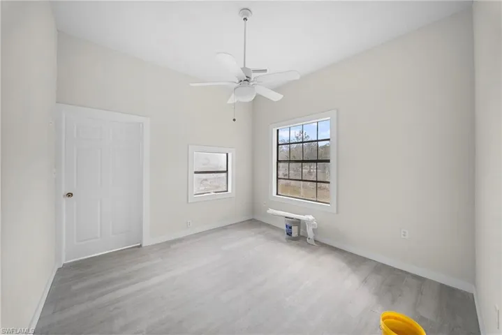 Spare room featuring light wood-style flooring and ceiling fan