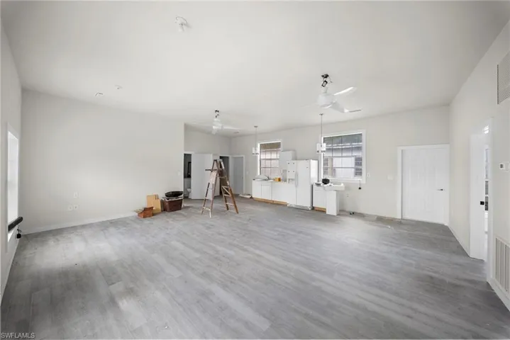 Unfurnished living room featuring ceiling fan and light wood-style flooring