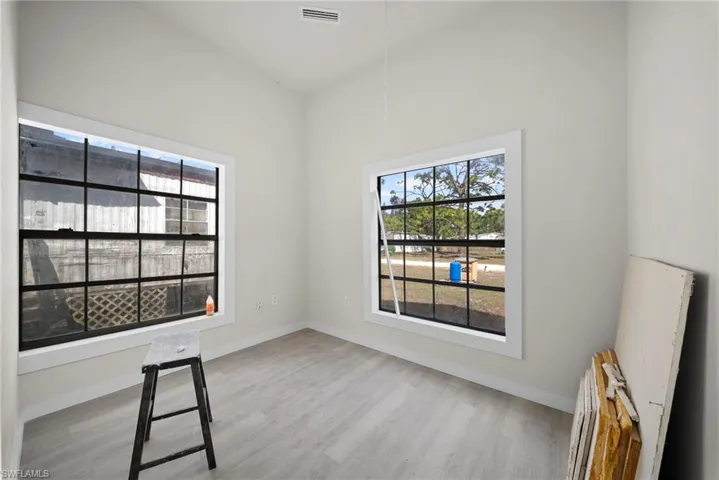 Spare room with light wood-style floors and baseboards