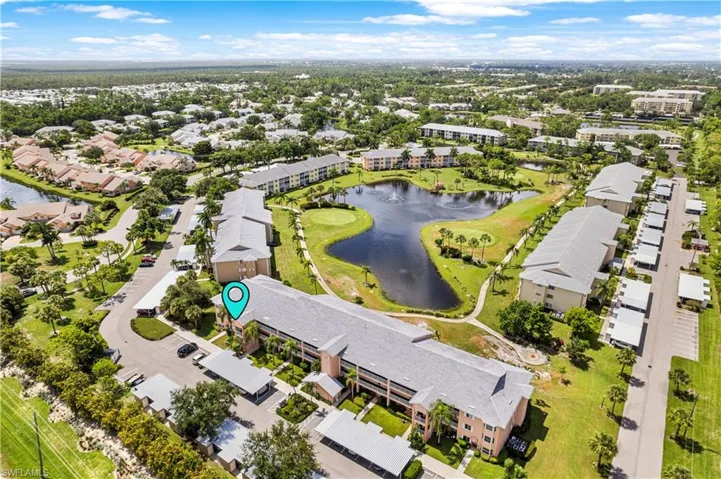 Birds eye view of property with a water view