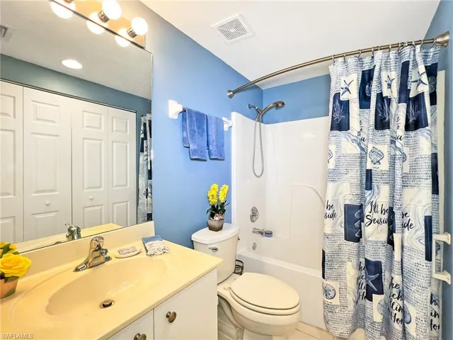 2nd Full bathroom featuring vanity, toilet, shower / tub combo, and tile patterned flooring