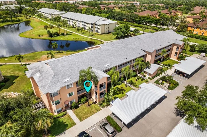 Birds eye view of property with a water view