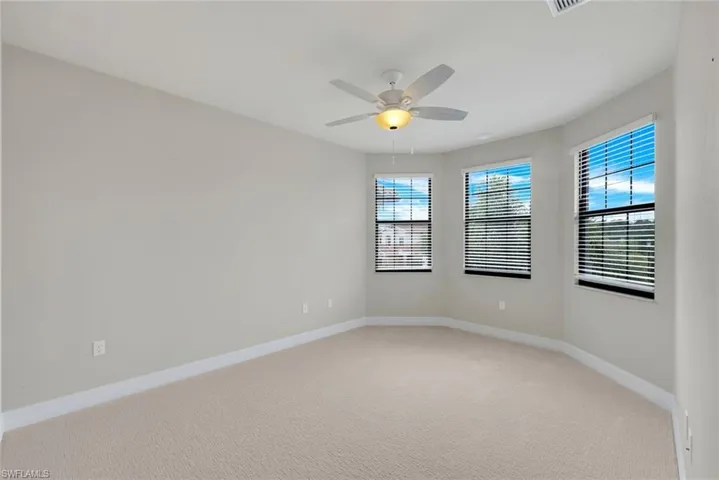3rd Bedroom Upstairs featuring new carpet, ceiling fan and bay windows