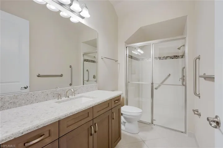Full downstairs guest bathroom- quartz counters, walk in shower