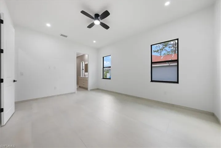 Empty room with visible vents, baseboards, a ceiling fan, and recessed lighting