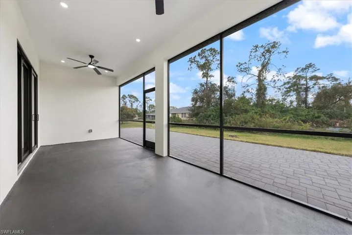 Unfurnished sunroom with ceiling fan