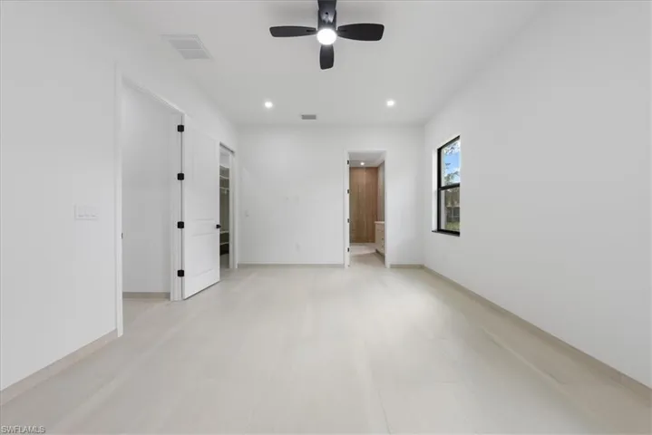Spare room with baseboards, visible vents, a ceiling fan, and recessed lighting
