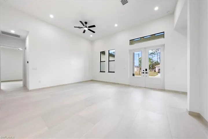 Unfurnished living room featuring recessed lighting, french doors, visible vents, and ceiling fan