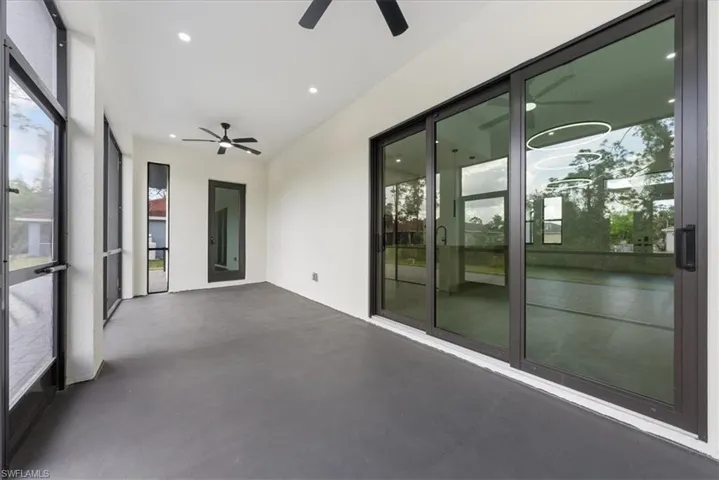 Unfurnished sunroom featuring a ceiling fan and a wealth of natural light