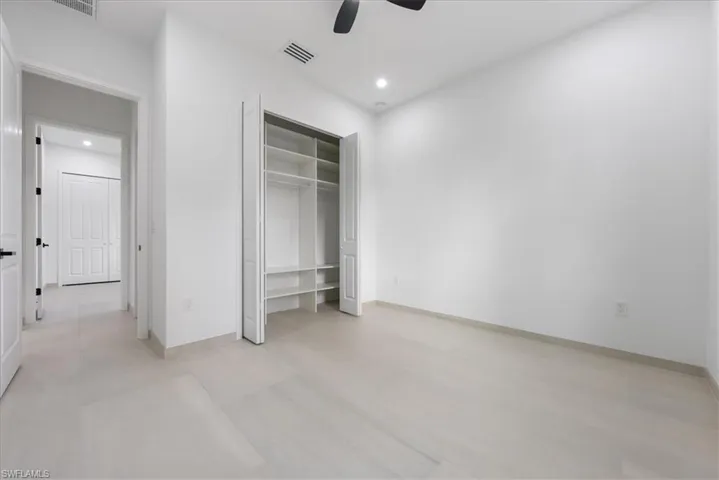 Unfurnished bedroom with baseboards, visible vents, and recessed lighting
