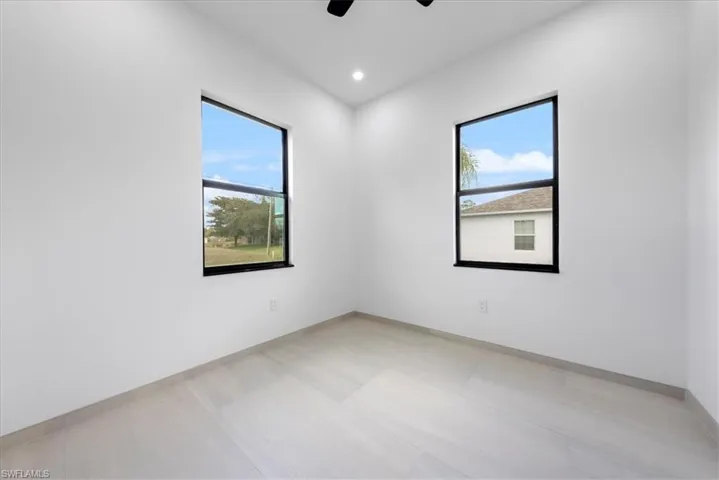 Empty room featuring baseboards, a ceiling fan, and recessed lighting