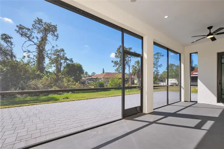 Unfurnished sunroom with concrete floors and recessed lighting