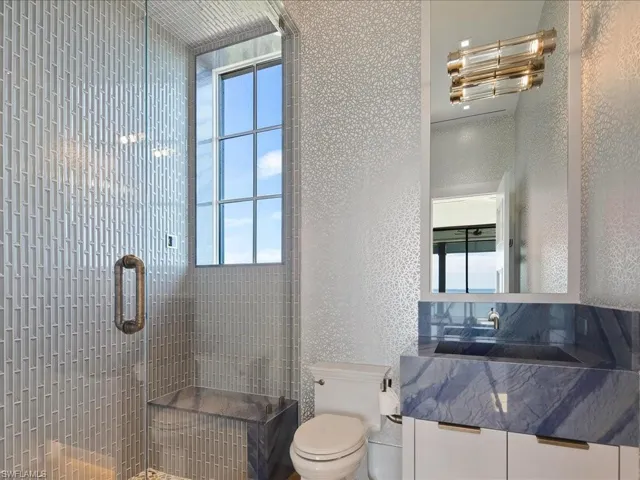 Bathroom featuring a stall shower, plenty of natural light, and vanity