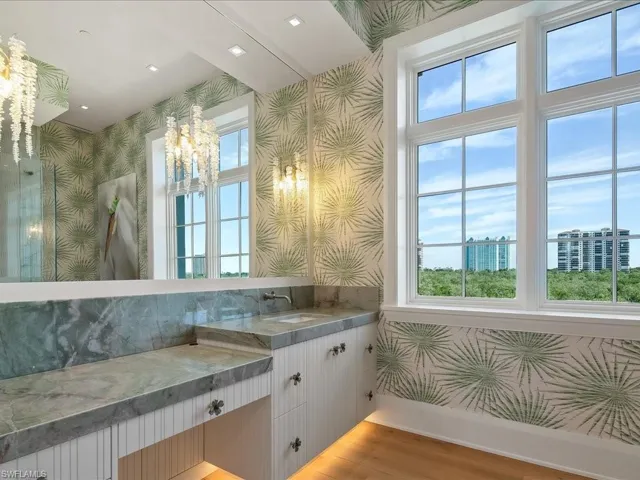 Full bathroom featuring wallpapered walls, vanity, plenty of natural light, and light wood-style flooring