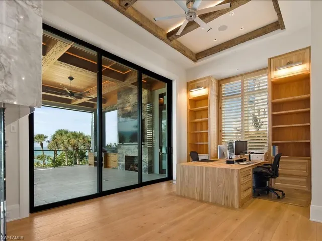 Office with a ceiling fan, healthy amount of natural light, and light wood-style floors